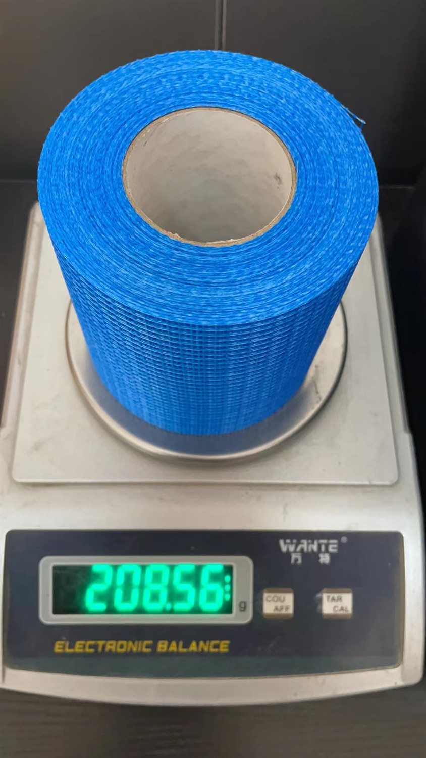 Blue fiberglass mesh roll shown on a weighing scale