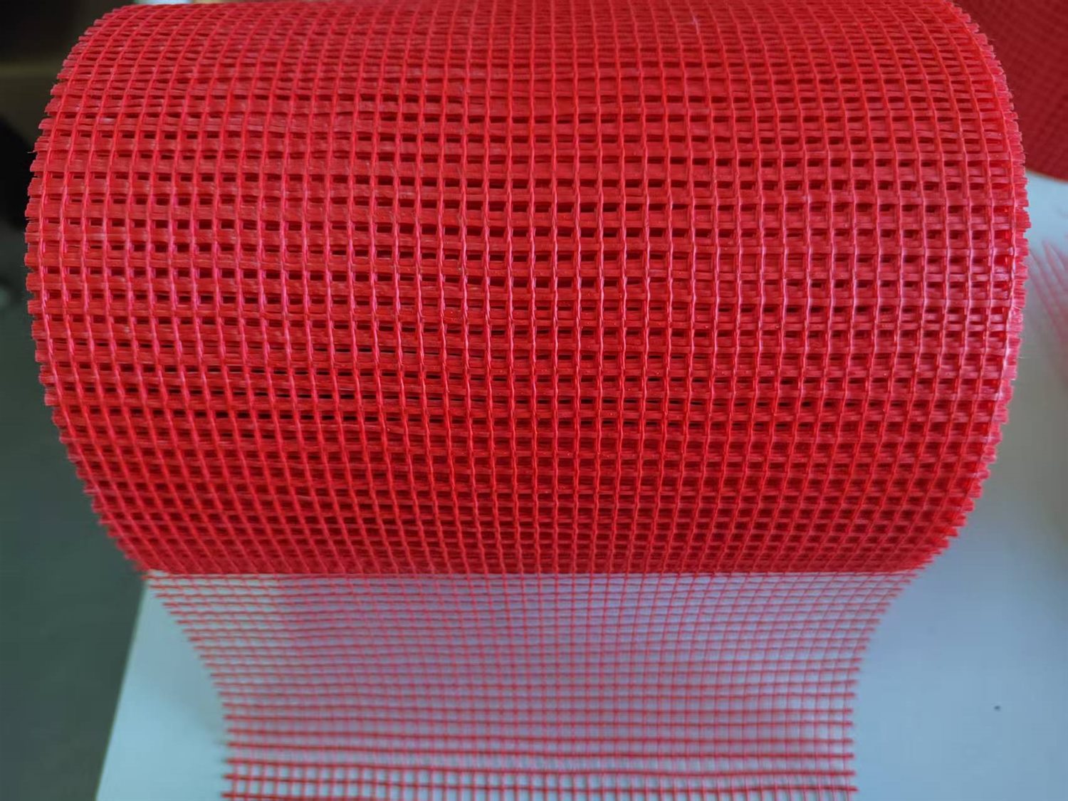 Red fiberglass mesh tape roll